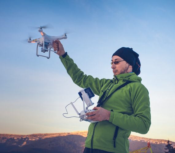Man operating a drone